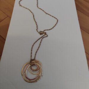 Long gold tone multi circle pendant necklace.